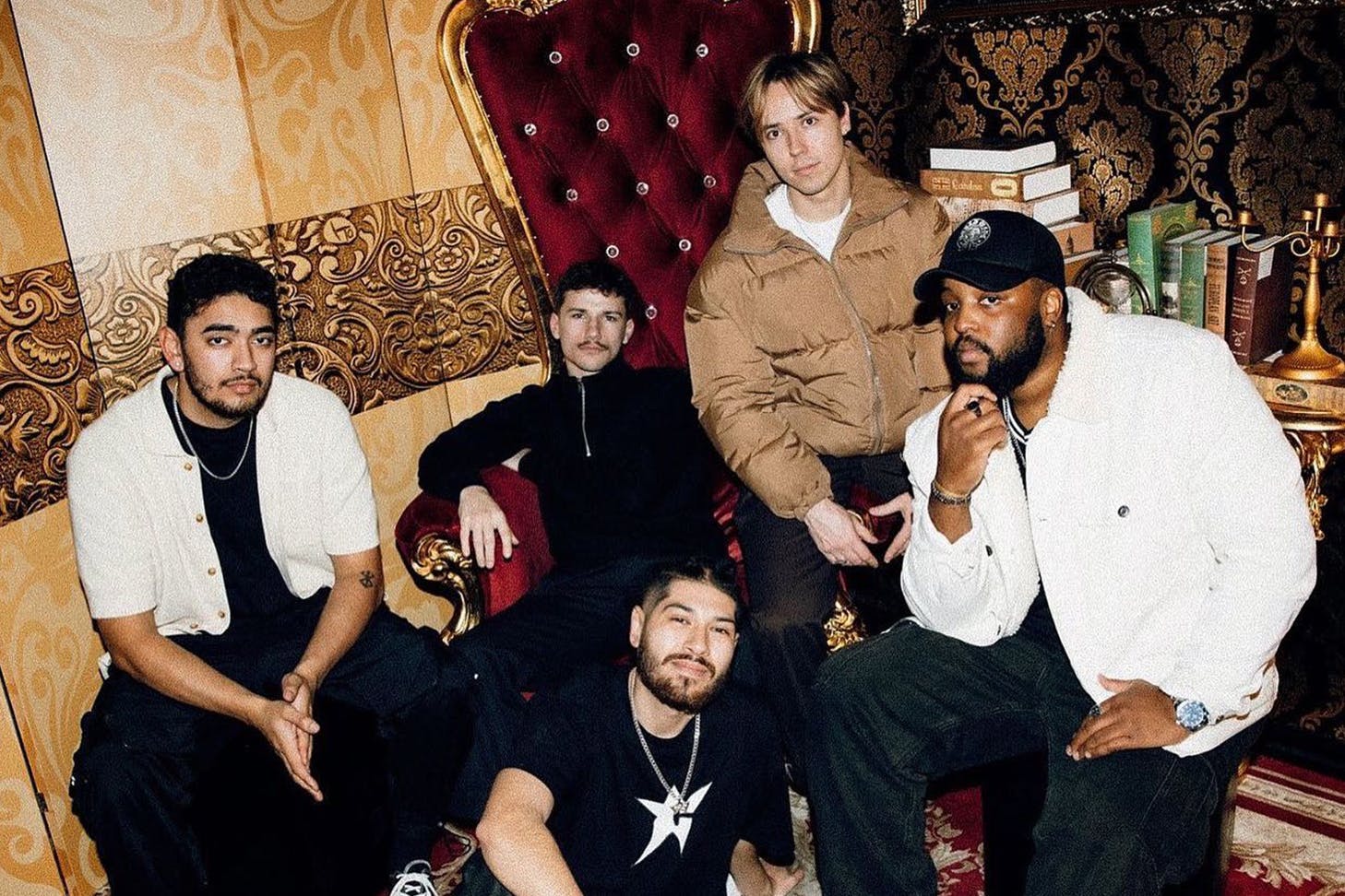 0800 Collective sitting in a living room.